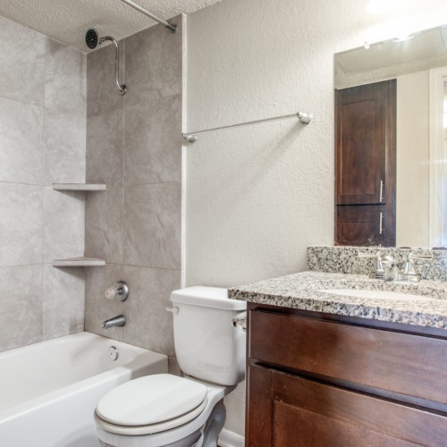 Large well lit bathroom with white accents 