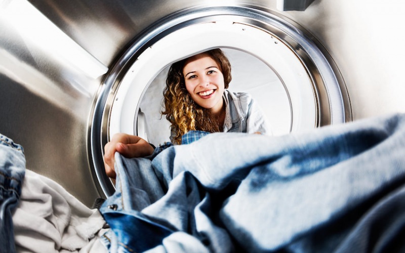 Woman taking clothes out of dryer